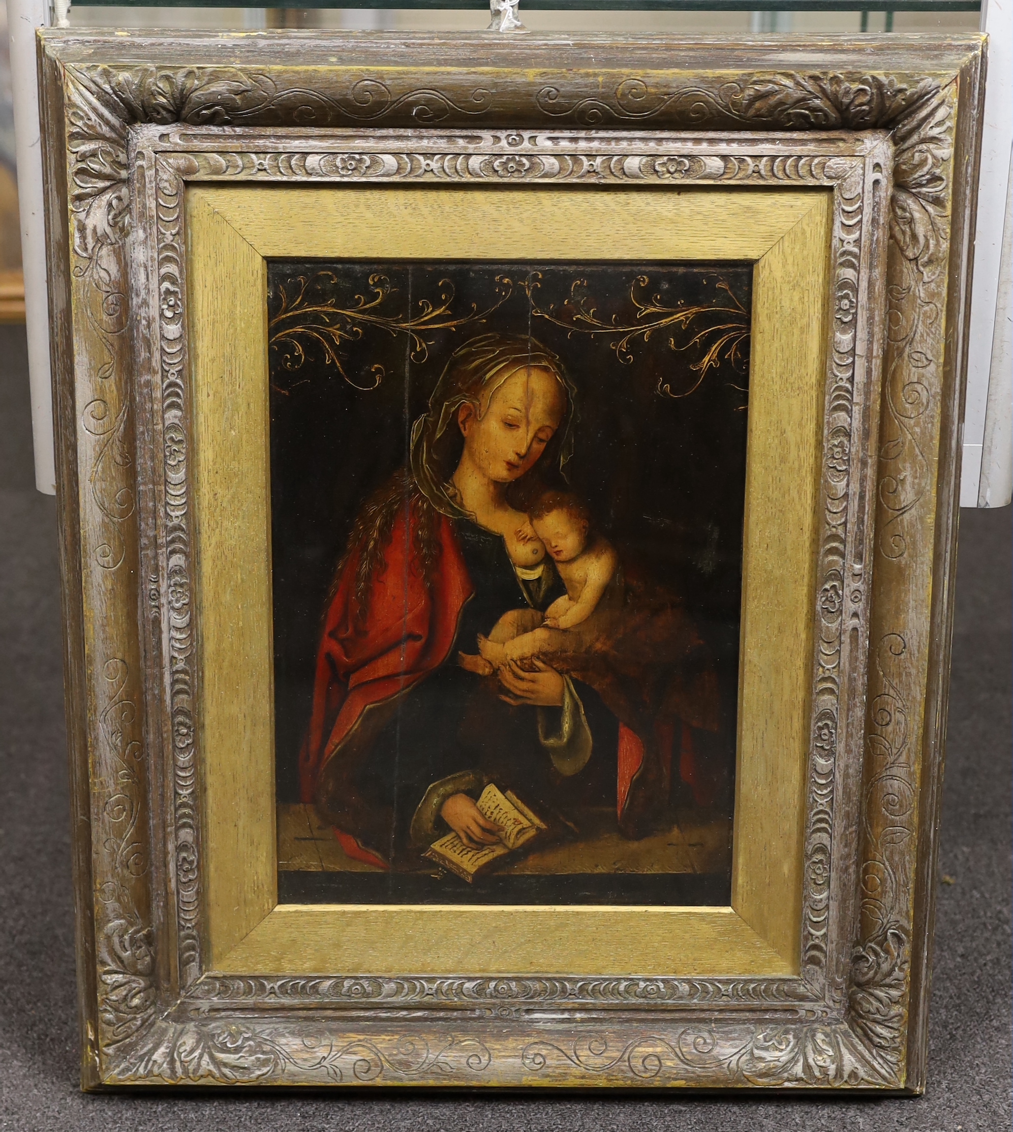 After Lucas Cranach (1472-1553), Virgin and child holding a missal, oil on wooden panel, 39.5 x 28cm